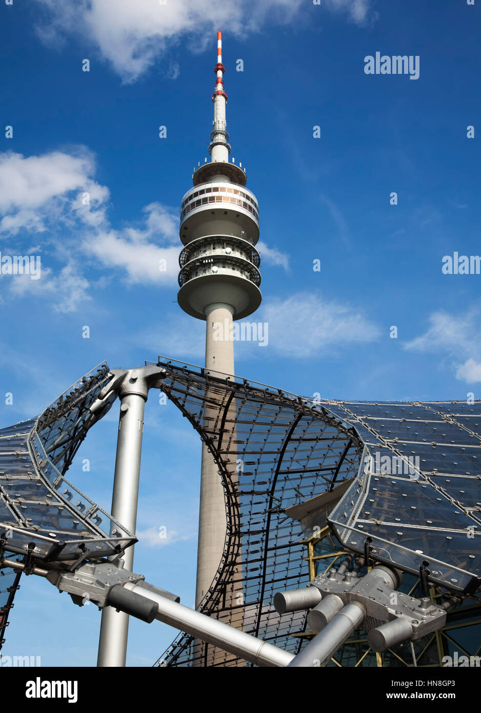 Munich, Germany - September 5, 2010: Olympiaturm tower and roof of olympic stadium. The tower has a height of 291 m and a weight of 52,500 tons. Stock Photo
