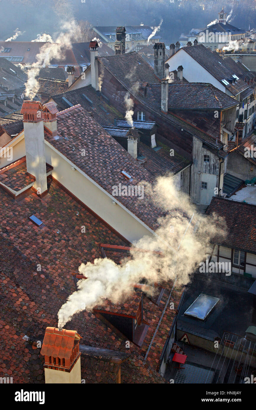 Chimneys smoking at the old town (Altstadt) of Bern, Switzerland. Stock Photo