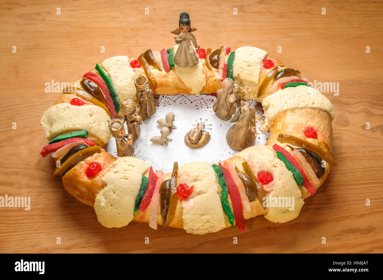 Epiphany Cake, kings cake, or Rosca de reyes with manger on wooden