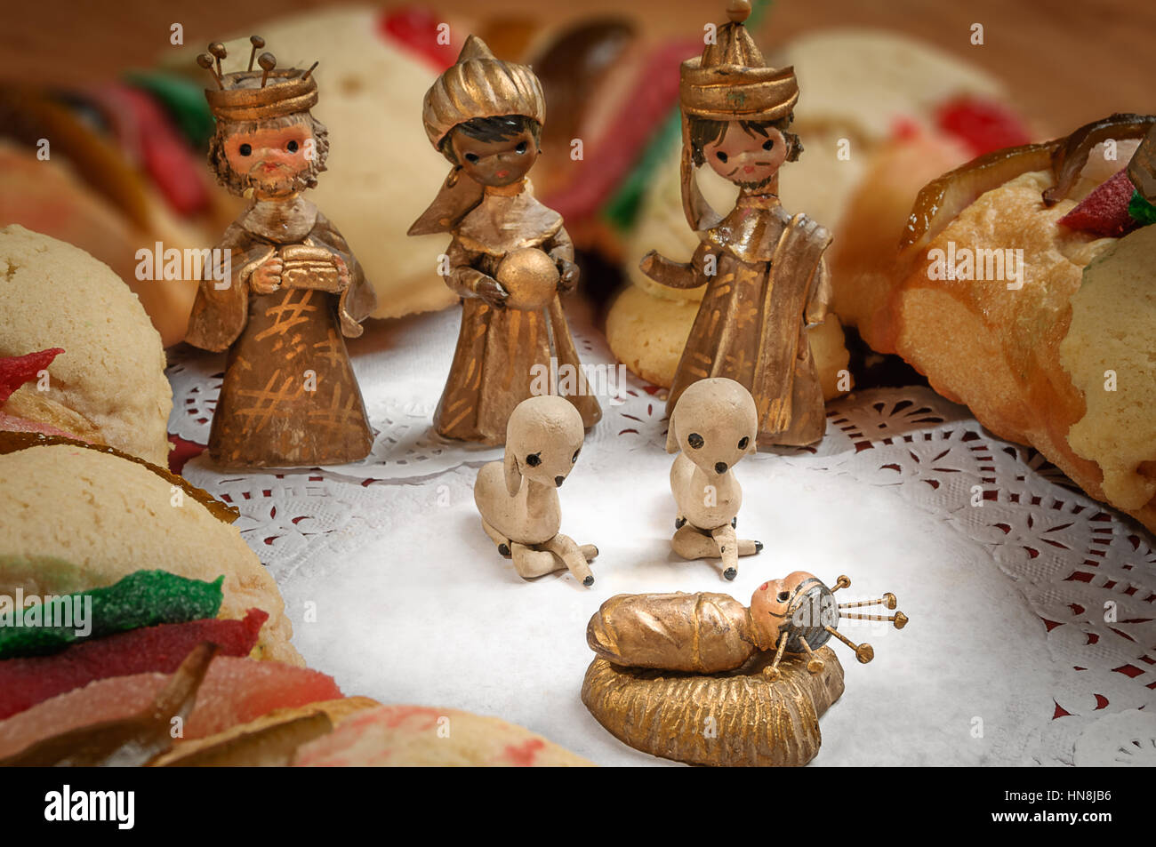 Epiphany Cake, kings cake, or Rosca de reyes with manger on wooden table Stock Photo