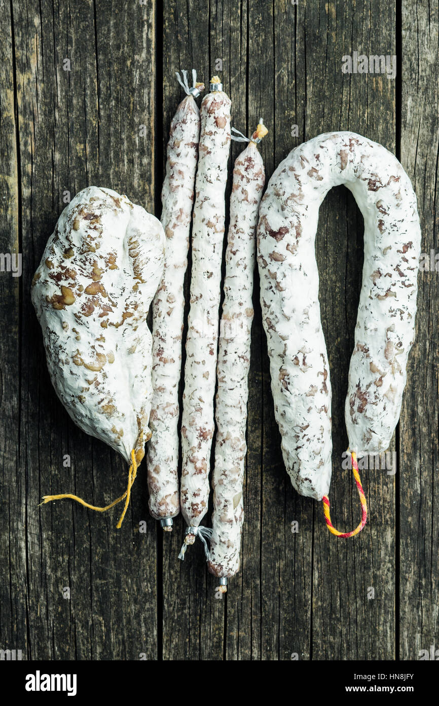 Tasty salami with white mold on kitchen table Stock Photo Alamy