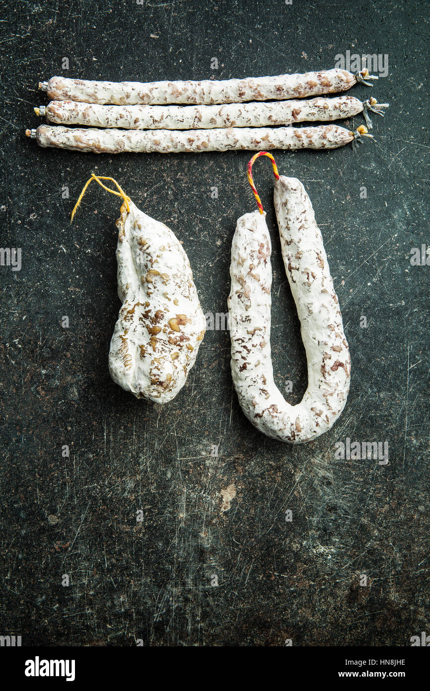 Tasty salami with white mold on kitchen table Stock Photo Alamy