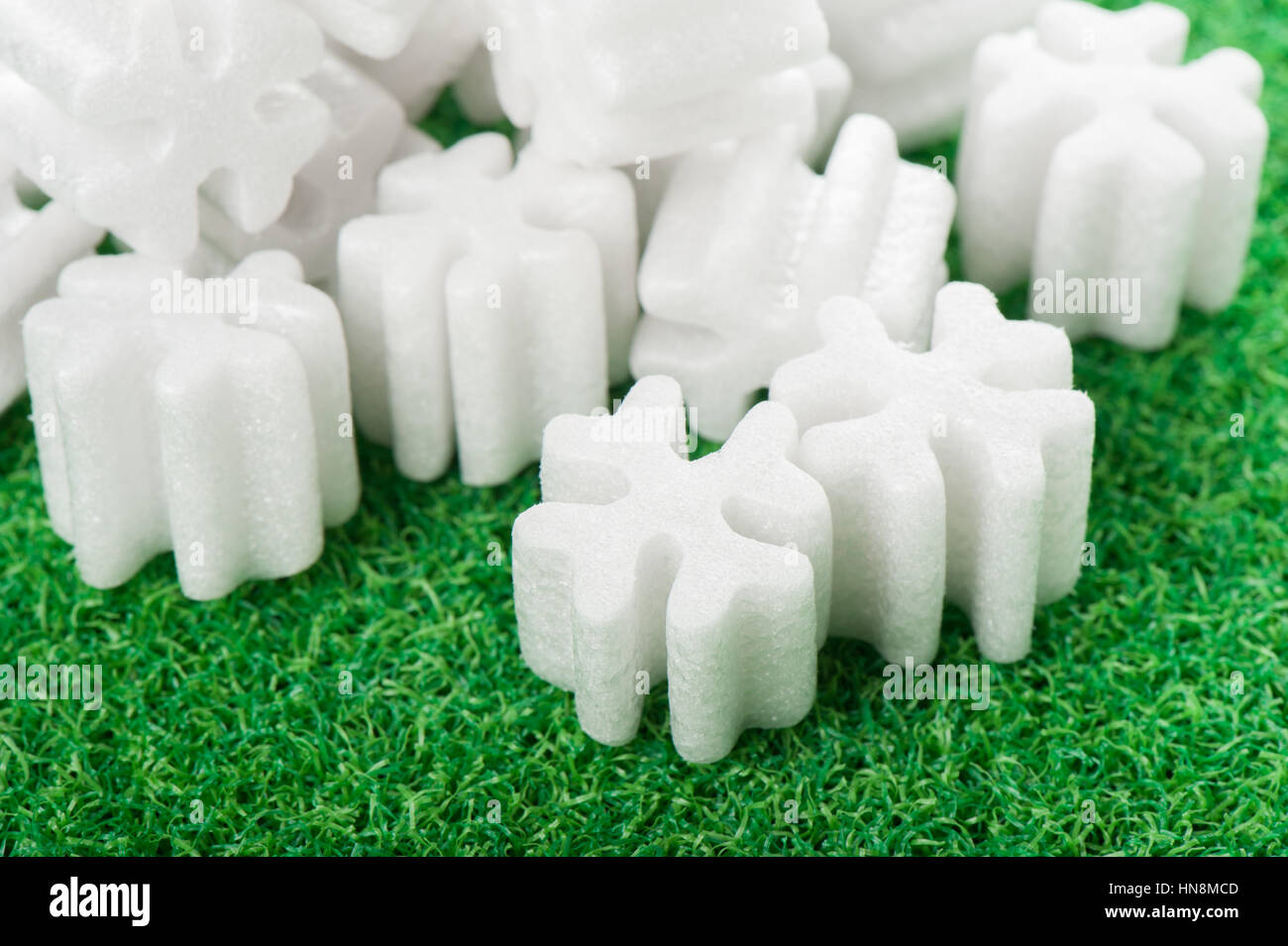 fill packing foam pellets on green background Stock Photo - Alamy