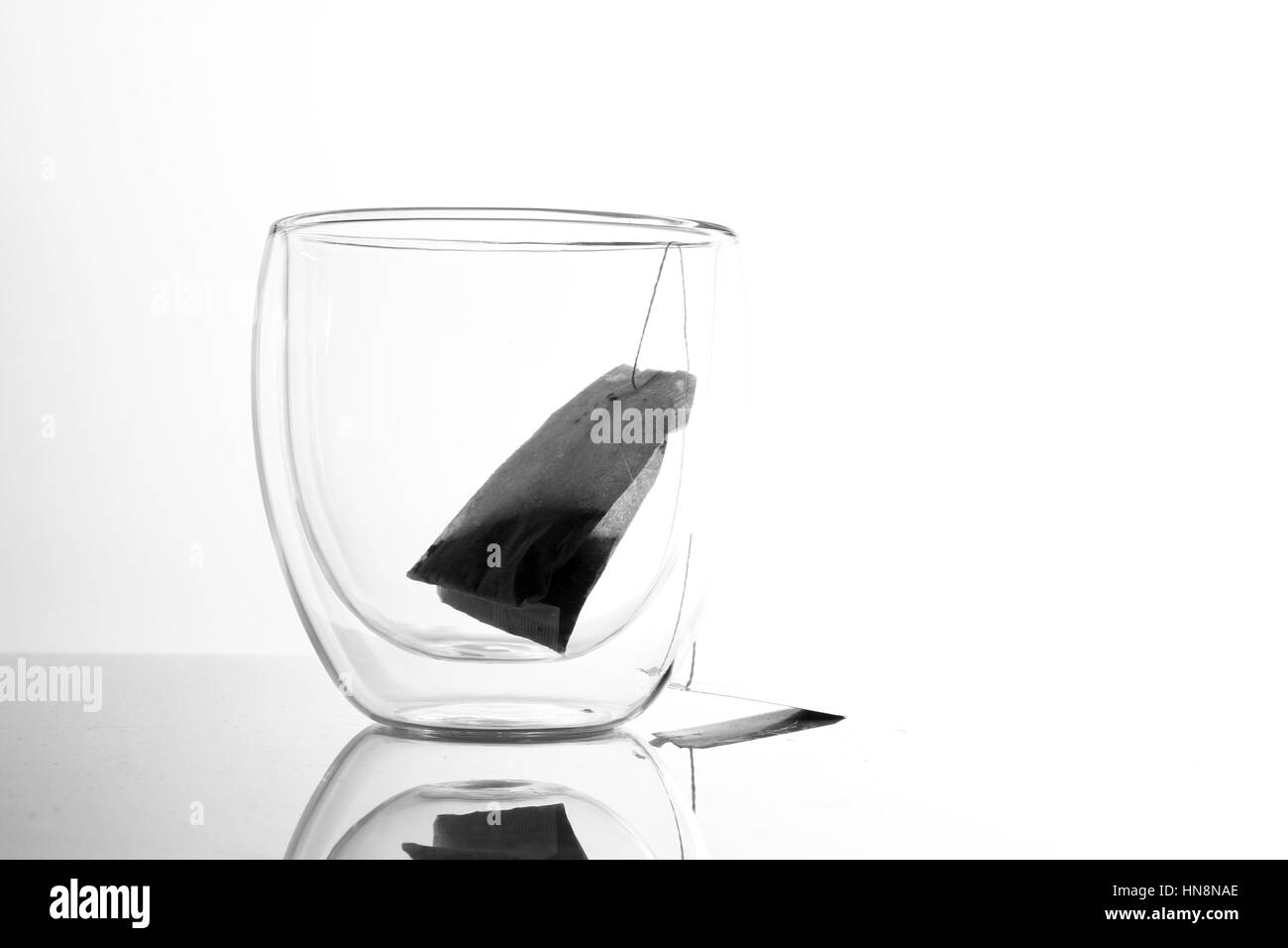 Glass with tea bag / Tea is an aromatic beverage commonly prepared by