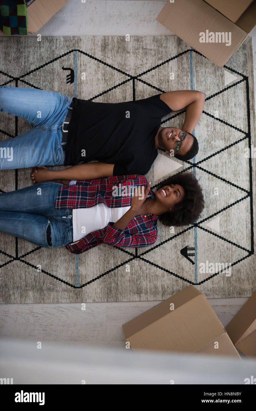 Top view of attractive young African American couple moving, holding ...