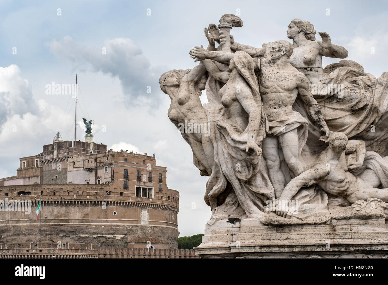 Rome, Italy- Close up of a Roman sculpture with Castel Sant'Angelo and the Hadrian's Mausoleum in the background built in 123 AD by Emperor Hadrian as Stock Photo