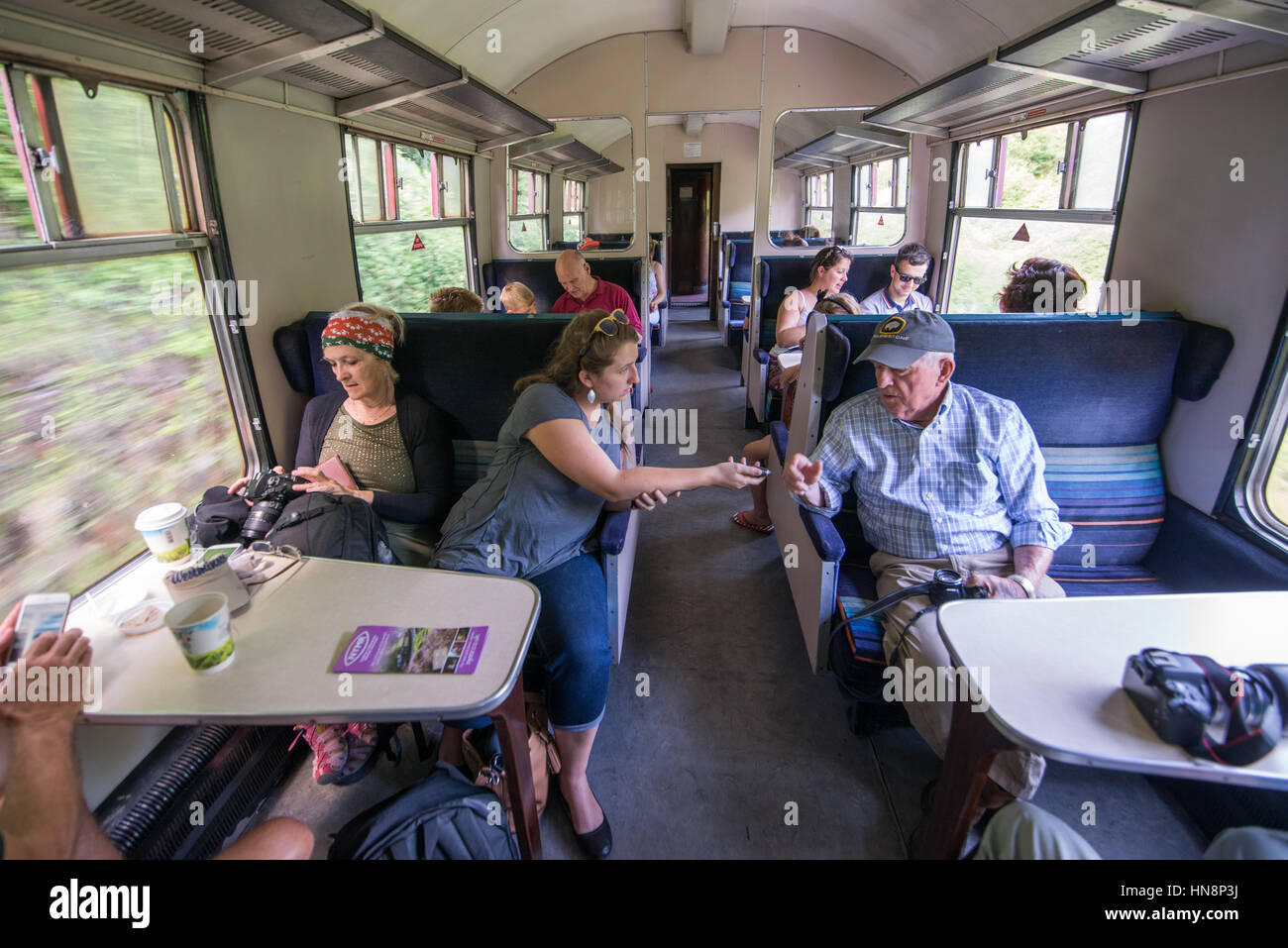 Passengers conversing on a train in the English countryside Stock Photo