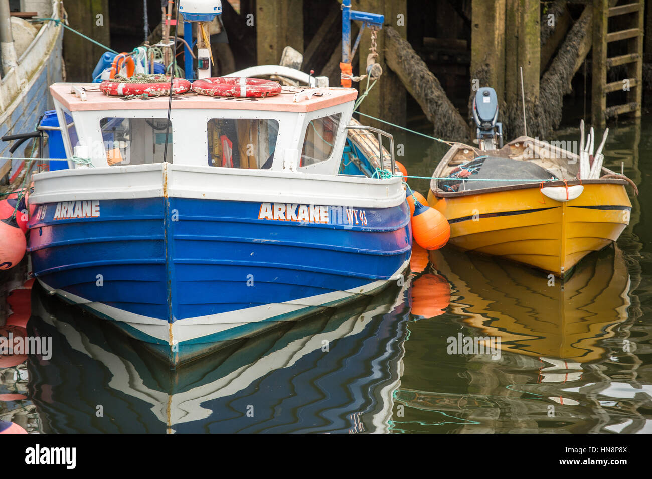 UK, England, Yorkshire - two boats docked together in the town of Whitby, England Stock Photo