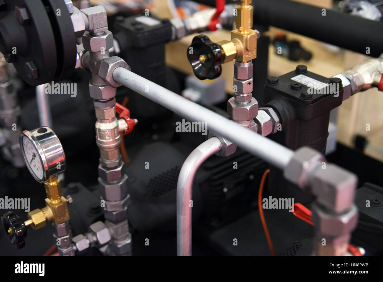 part of pipeline system with plastic tubes, ball valves and measuring device Stock Photo