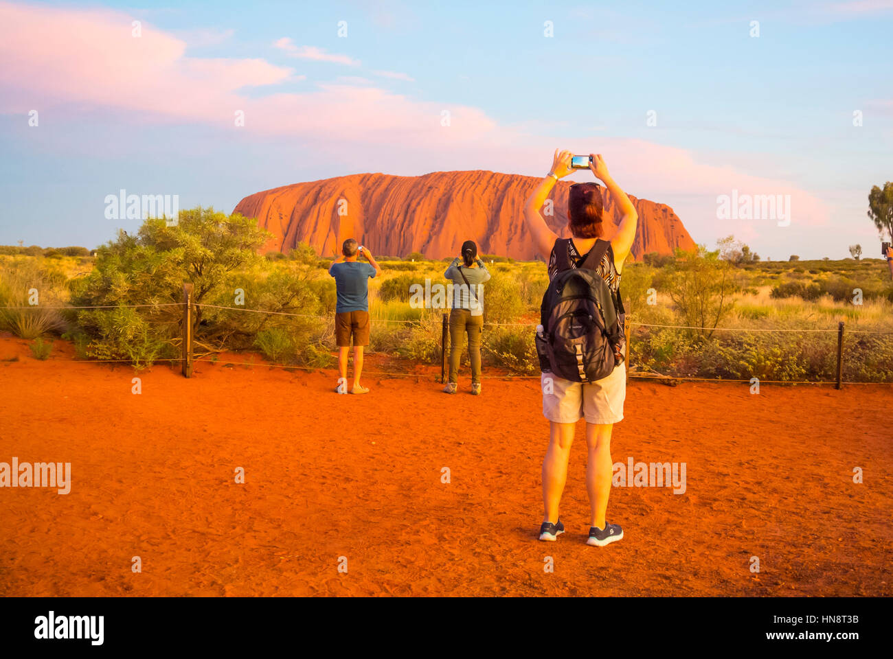 Tourists snapping the Sunset Ayers Rock Australia Stock Photo