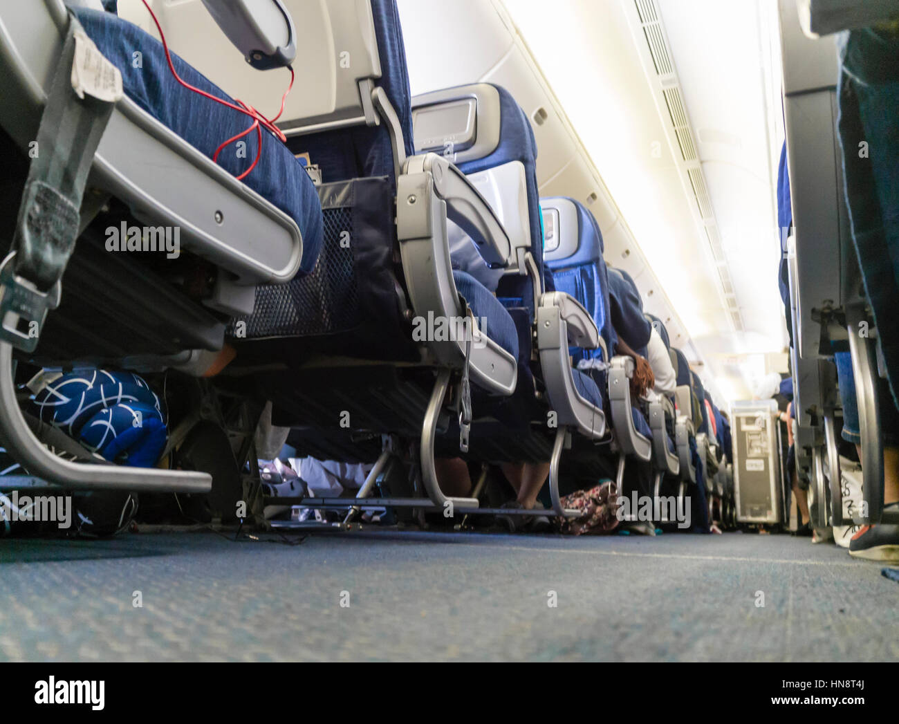 Looking down the aisle inside  the cabin of a passenger airplane during flight. Stock Photo