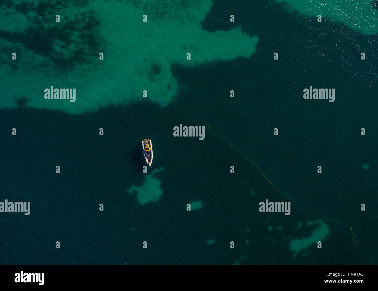 Aerial view of one boat in turquoise ocean water Stock Photo - Alamy