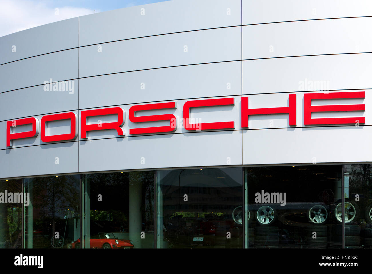 Porsche signage at car dealer's building. Porsche is a luxury high
