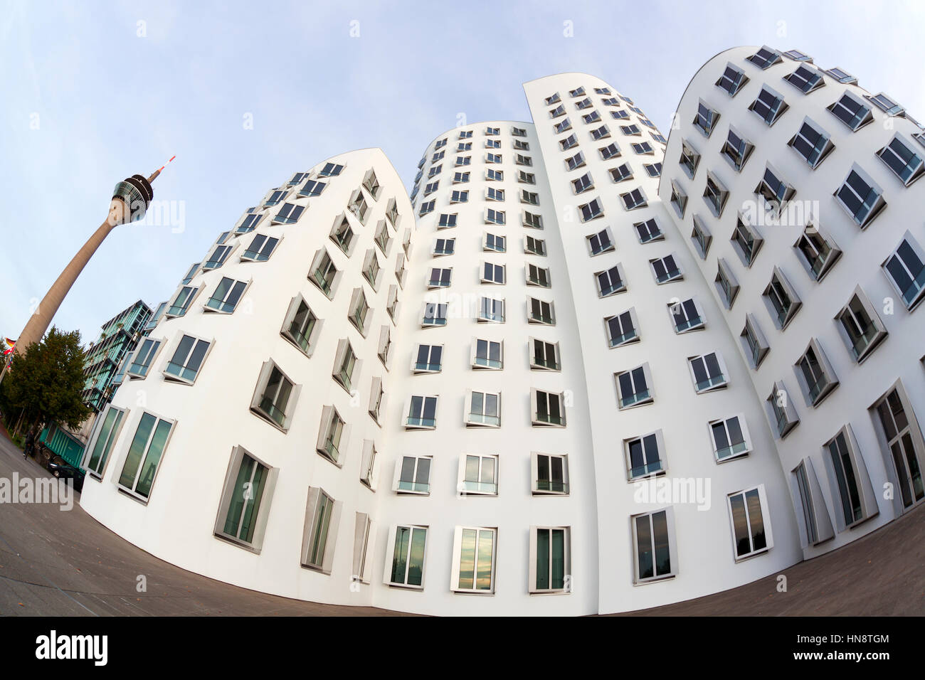 Dusseldorf, Germany - September 10, 2011: Fisheye view of Frank Owen Gehry's 'Neuer Zollhof' building at the Mediaharbor and the Rhine Tower. Stock Photo