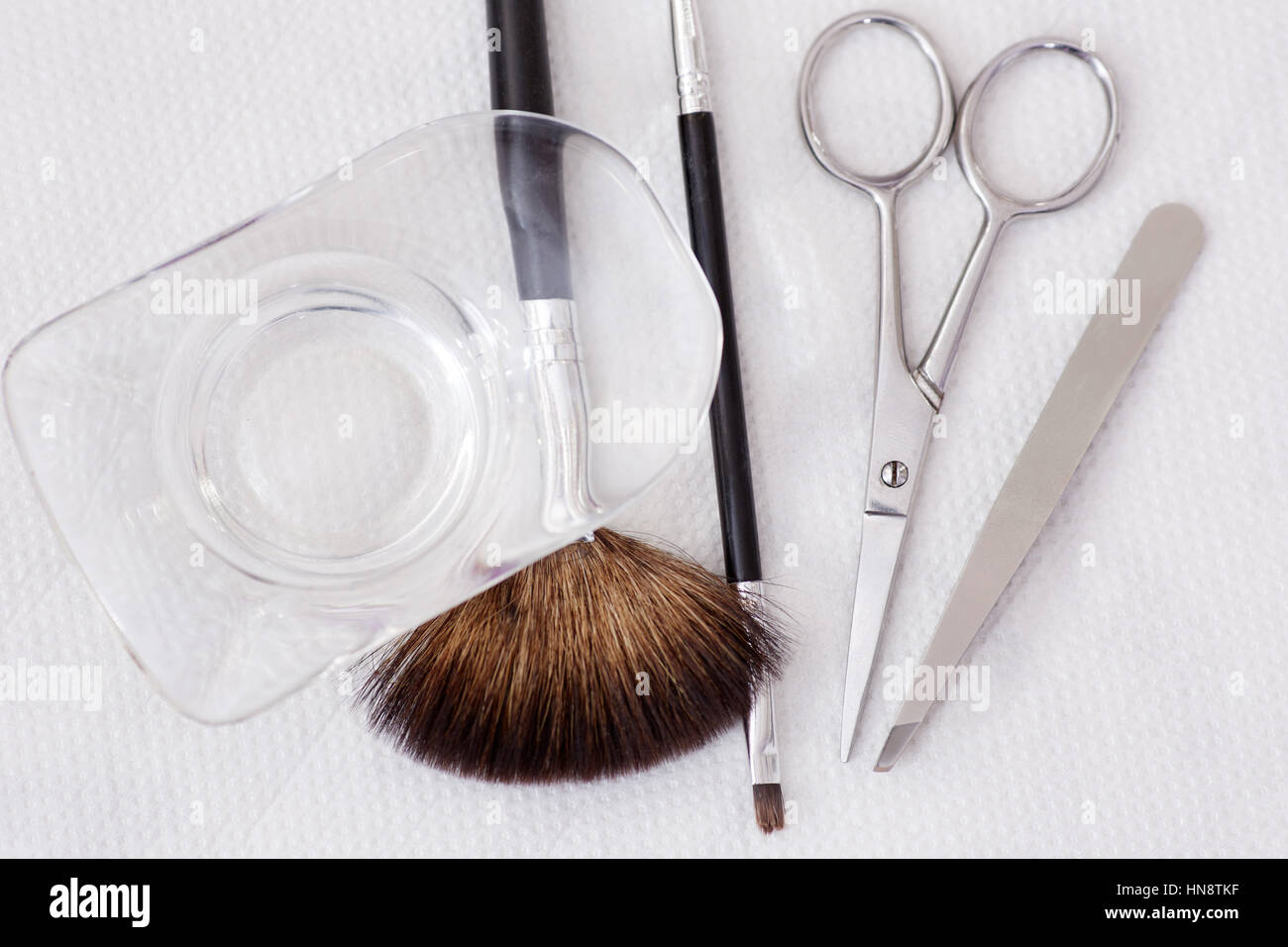 Crop of cosmetologist work place in beauty salon, tools for permanent