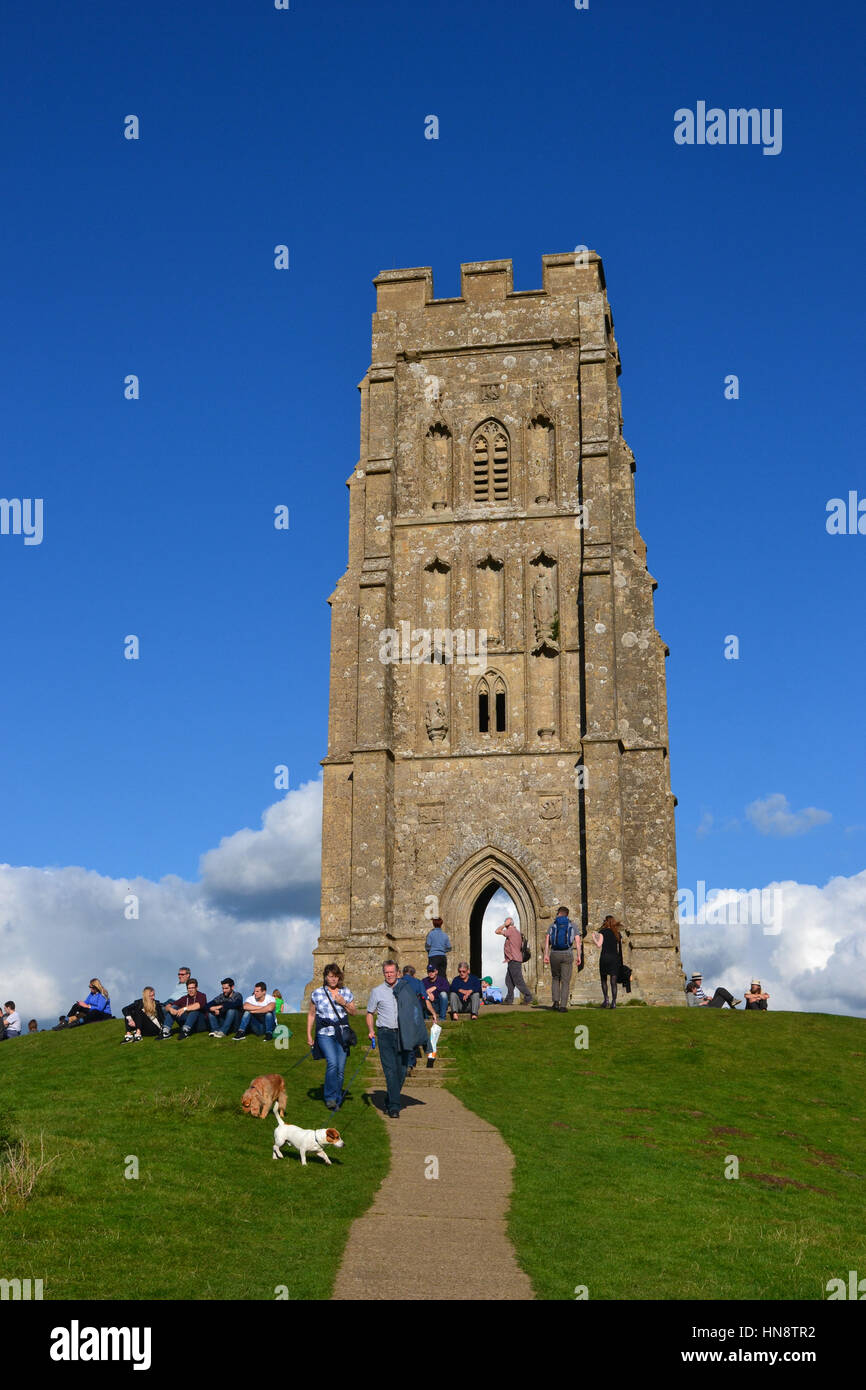 A busy day at Glastonbury Tor, Somerset, UK. People walking two dogs Stock Photo