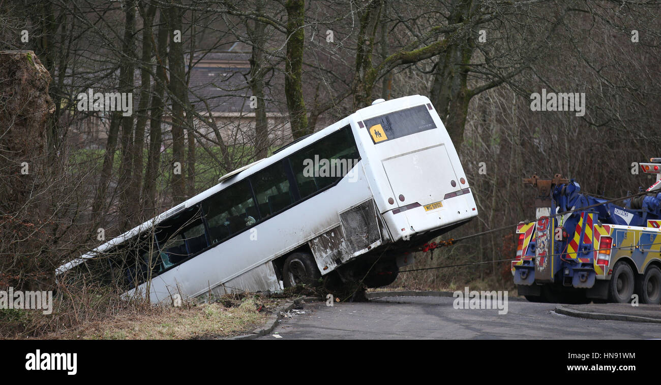 Emergency services work to right a school bus which overturned near Our Lady's High School in Cumbernauld, Lanarkshire. Stock Photo