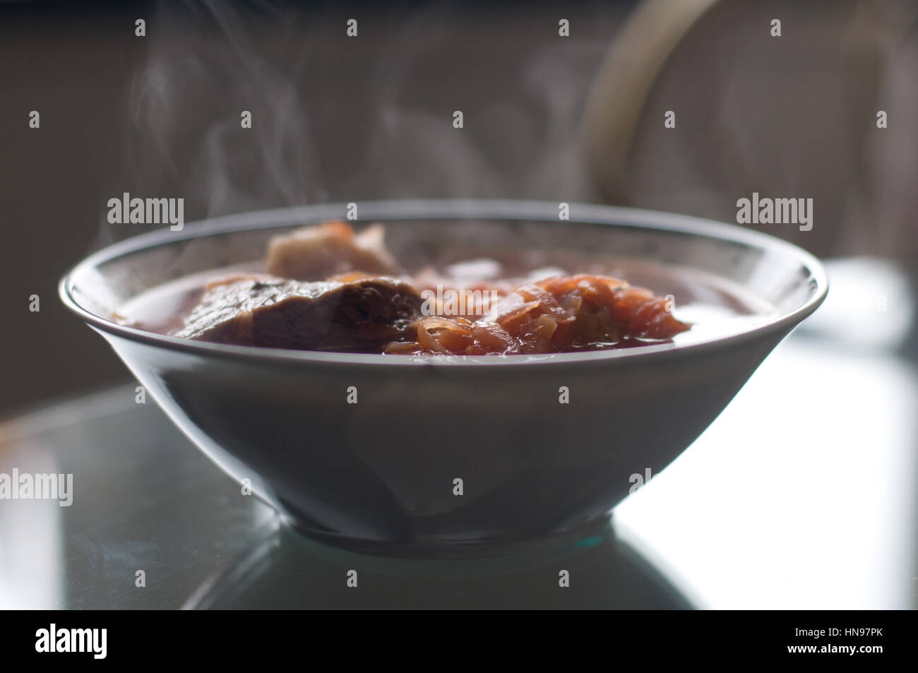 Borscht ukrainian national cuisine on the table in deep plate with steam Stock Photo