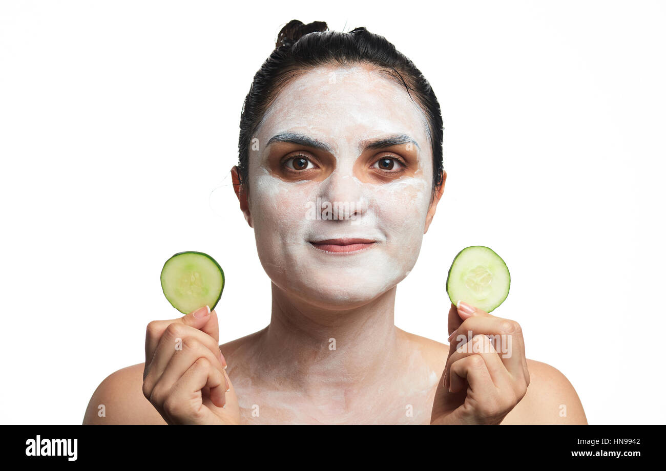 woman make skin treatment with slices cucumbers isolated on white Stock Photo