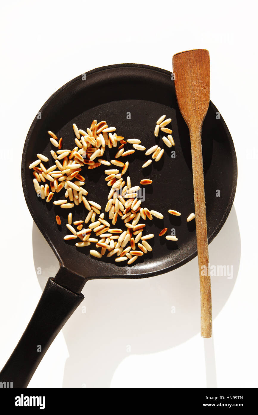 roasted pine nuts in pan Stock Photo