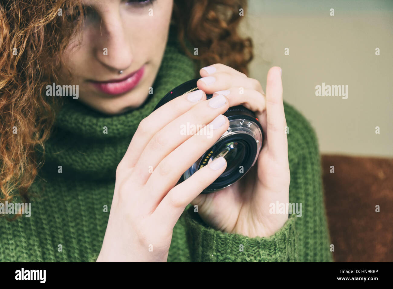 Young woman testing a camera lens Stock Photo Alamy