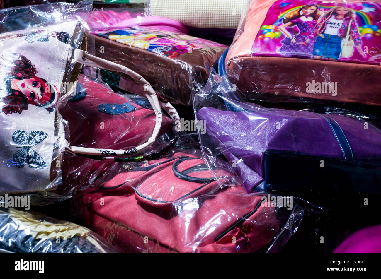 Pile of colorful, low budget purses for ladies. These are popular items at the cutting edge of fashion Stock Photo