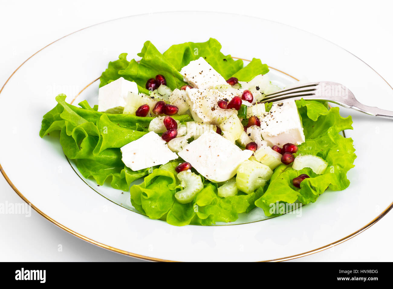 Lettuce, celery, feta, pomegranate seeds on a white Stock Photo Alamy