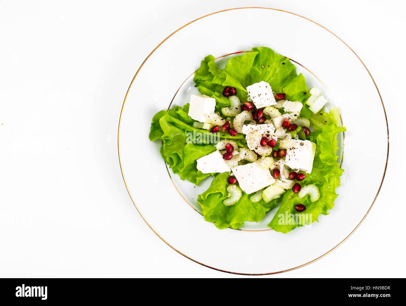 Lettuce, celery, feta, pomegranate seeds on a white Stock Photo Alamy