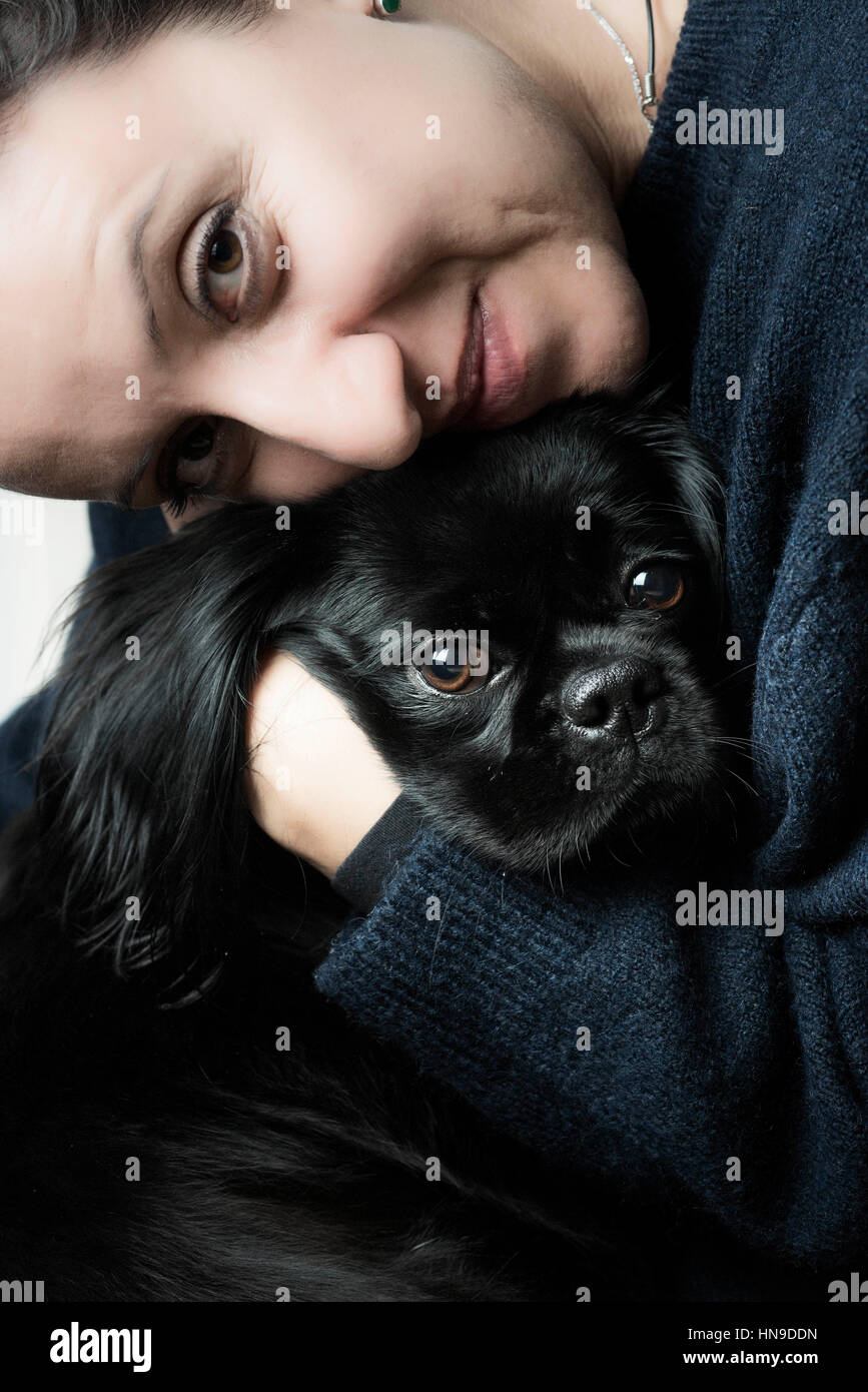 Woman cuddles her pedigree dog Stock Photo