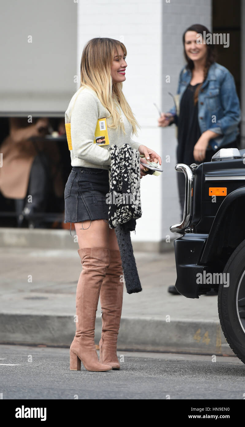 Hilary Duff's mustard yellow dress and knee-high boots make her