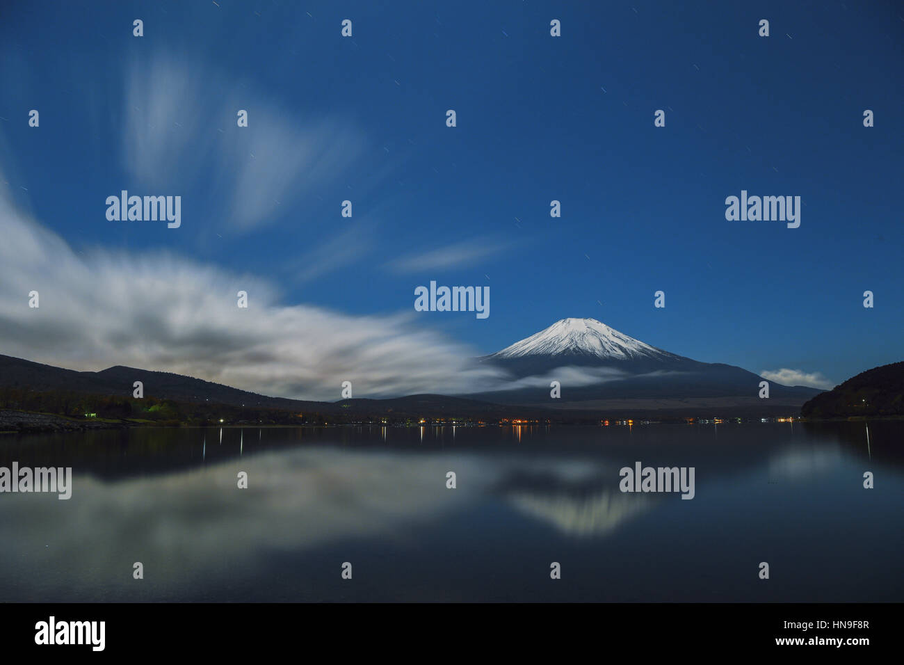 Night view of cloudy sky and Mount Fuji at night from Lake Yamanaka ...