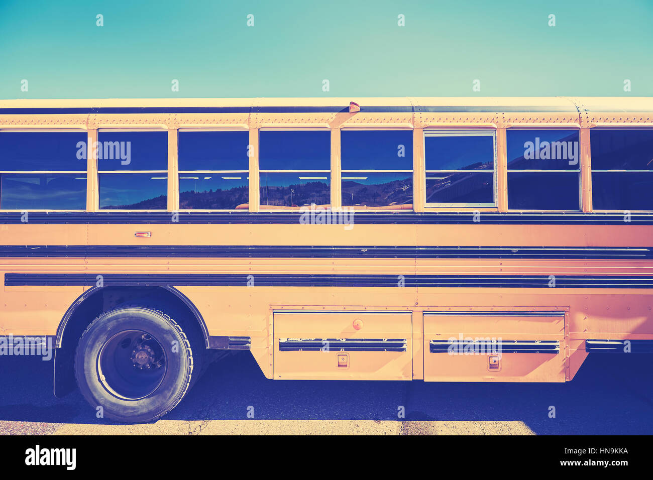 Retro stylized close up picture of a school bus side. Stock Photo