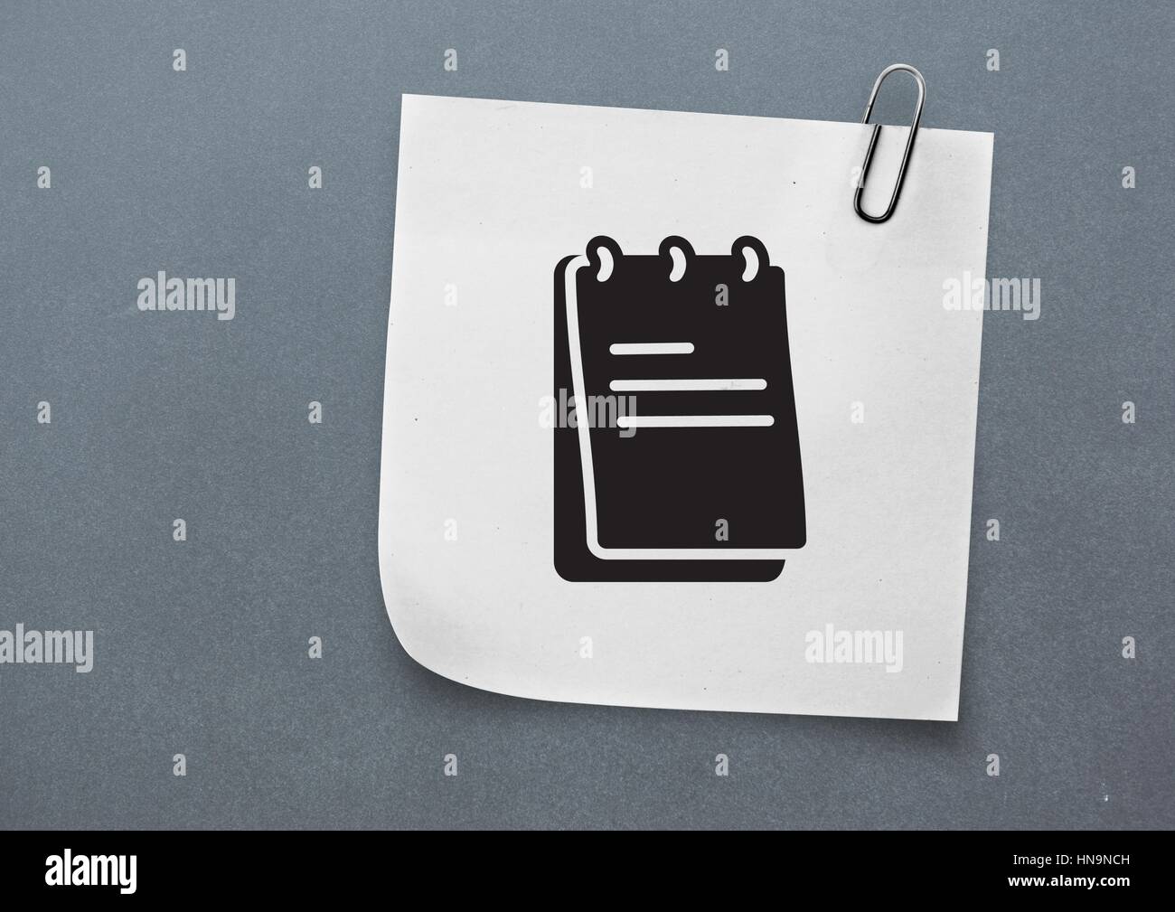 Digital composite of Sticky Note with Notepad Icon against neutral grey ...