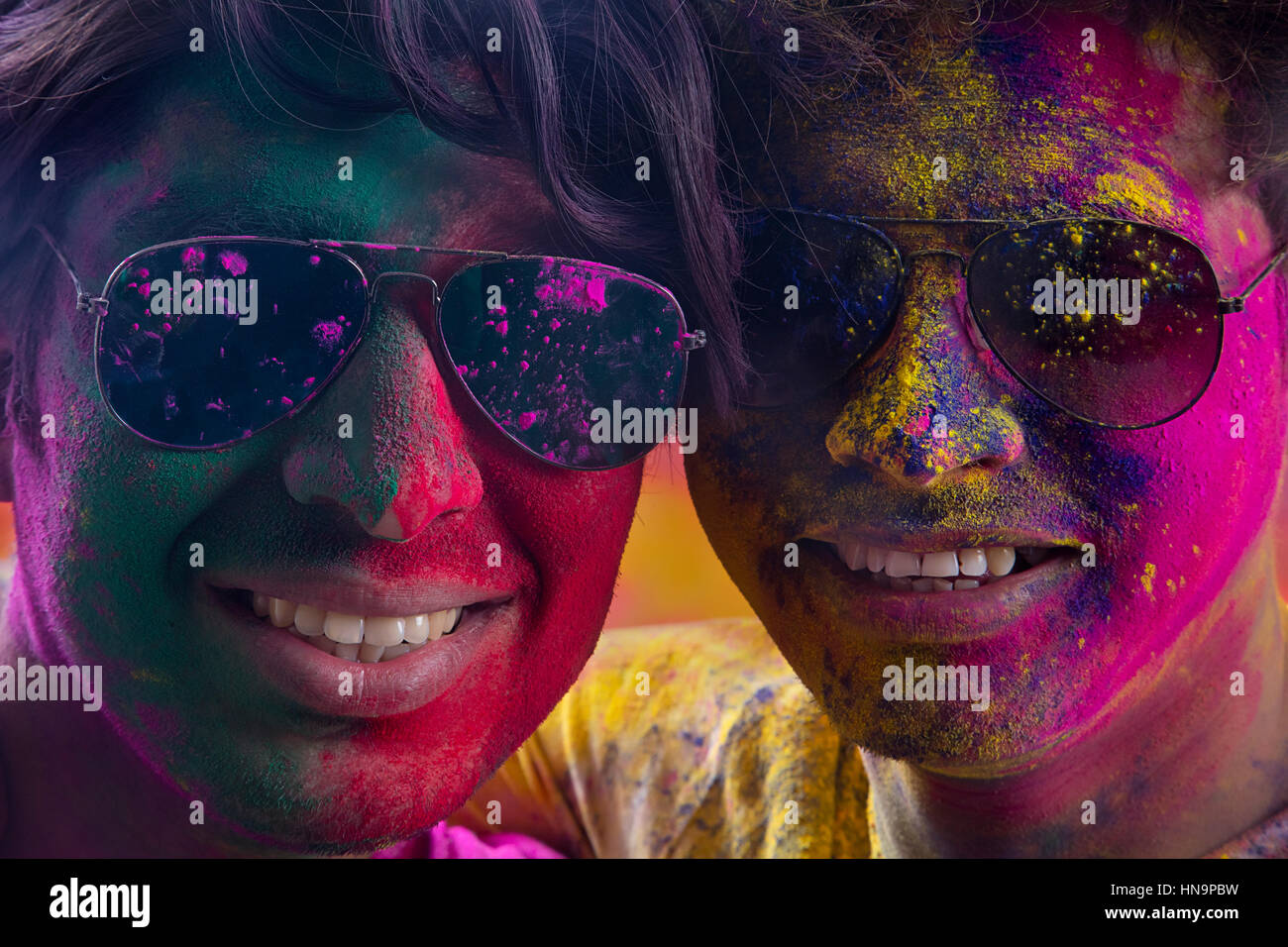 Portrait Of Young Two Men With Paint On Face During Holi Stock Photo