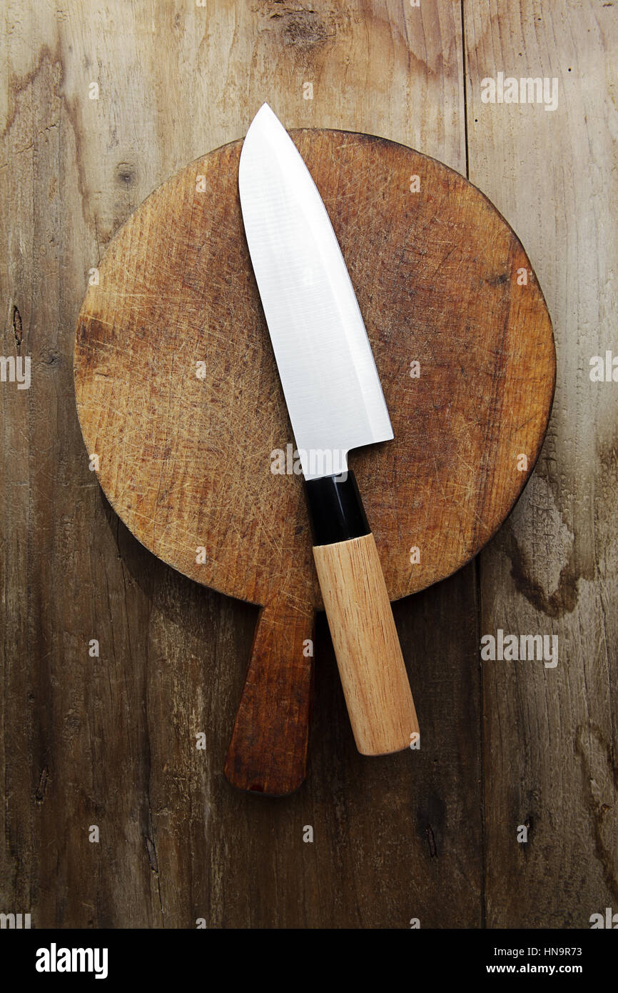 japanese Knife on a cutting board on a wooden table Stock Photo