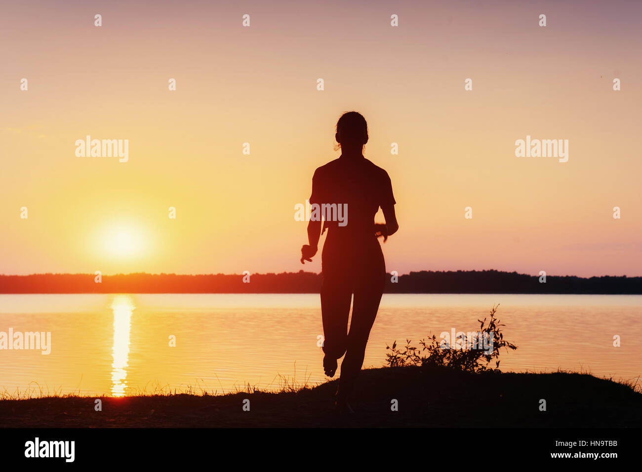 girl at sunset by the lake Stock Photo - Alamy