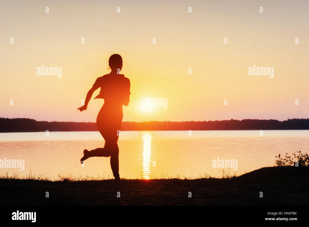 girl at sunset by the lake Stock Photo - Alamy