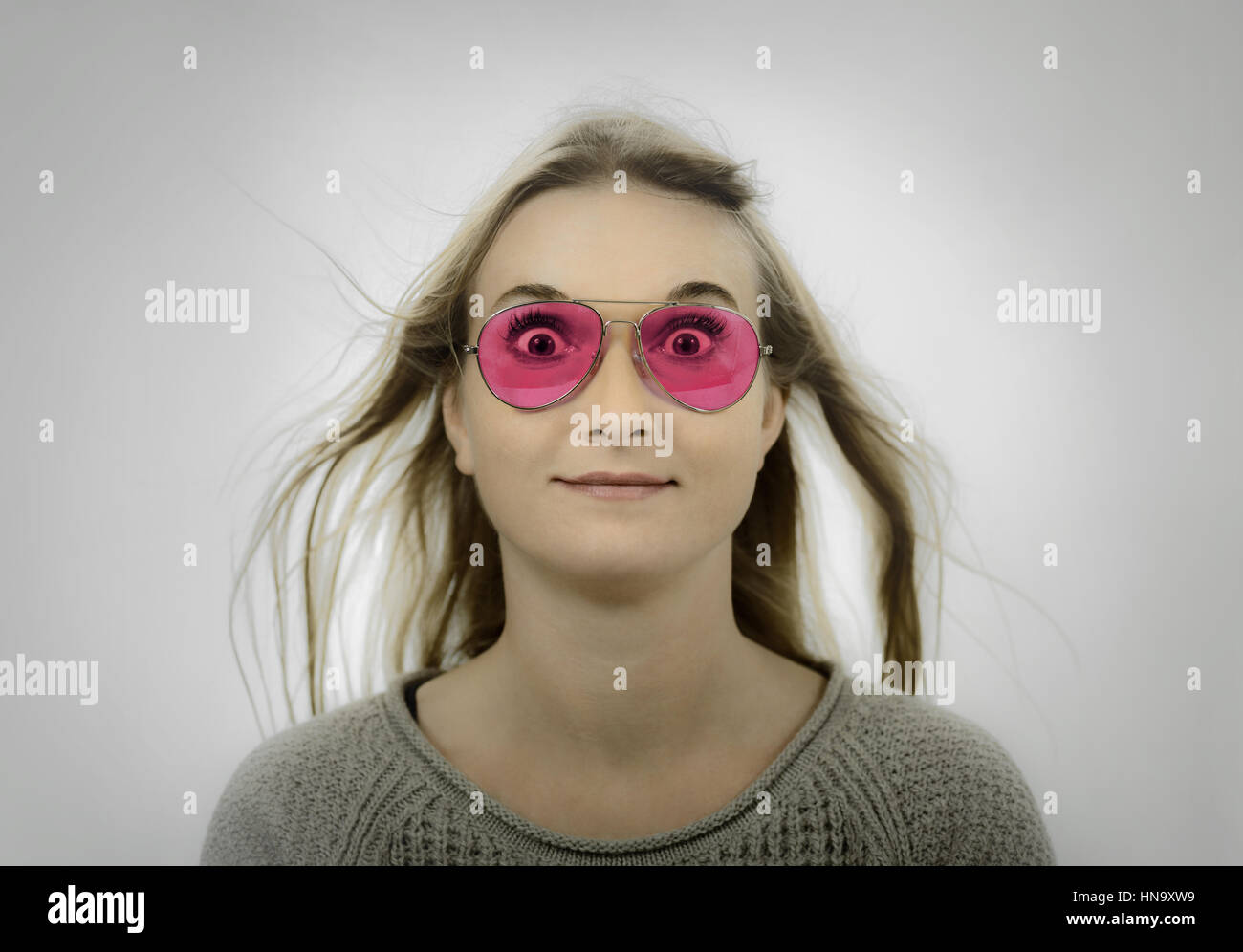Woman wearing rose tinted sunglasses Stock Photo - Alamy