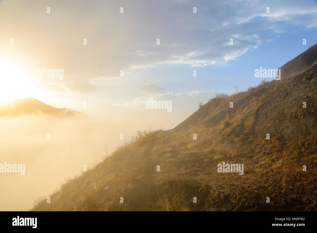 Morning sunburst over Alamat Castle in the Alborz mountains, Iran Stock Photo