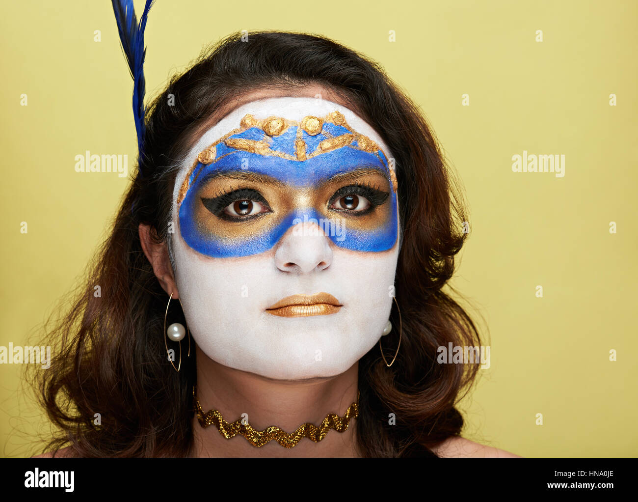 portrait of woman with body art on yellow background Stock Photo