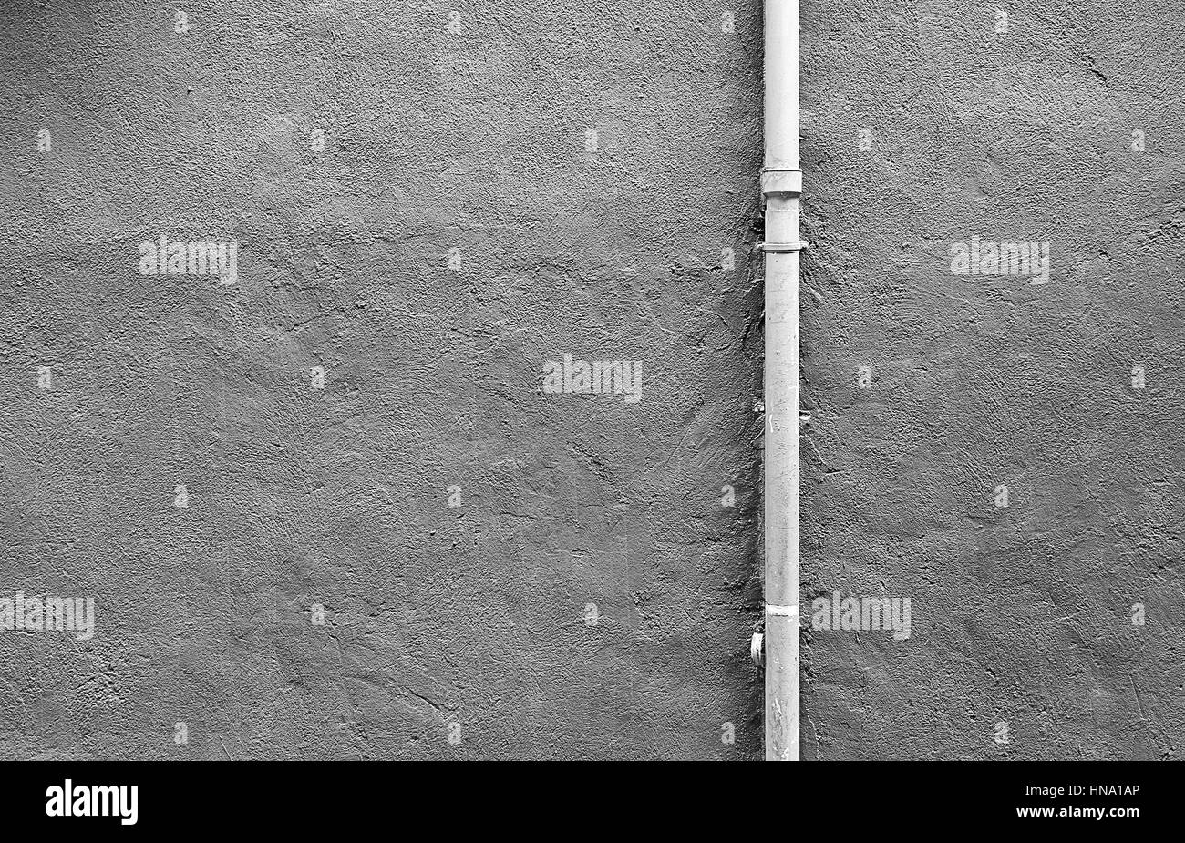 Pipe cement wall, detail of a wall painted with a metal pipe, outdoor