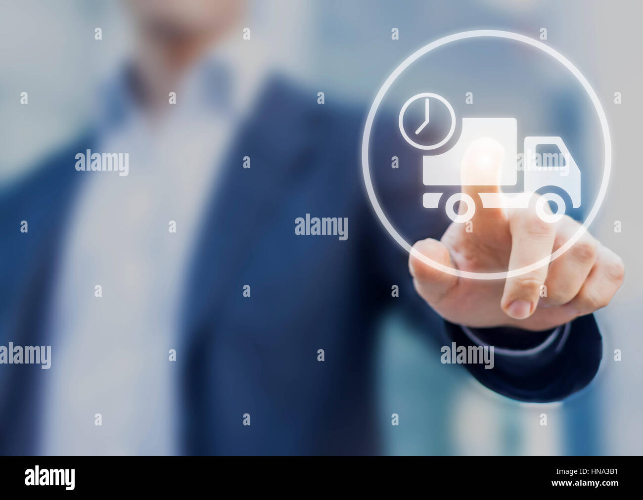 Delivery concept with a business person touching a truck icon on a computer screen, e-commerce and logistic Stock Photo