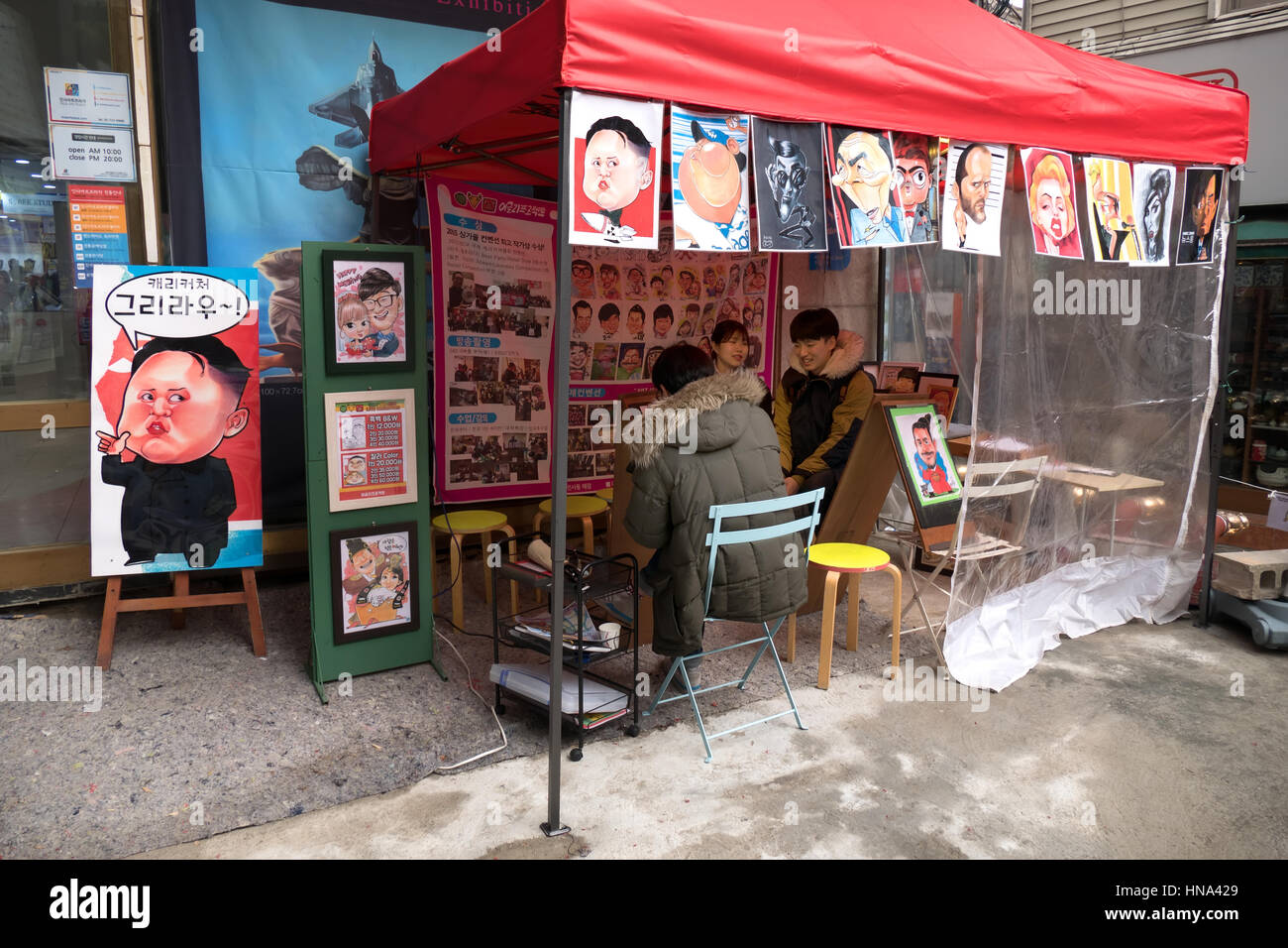 Man painting caricatures. Stall selling paintings of celebrities. Seoul, South Korea, Asia Stock Photo