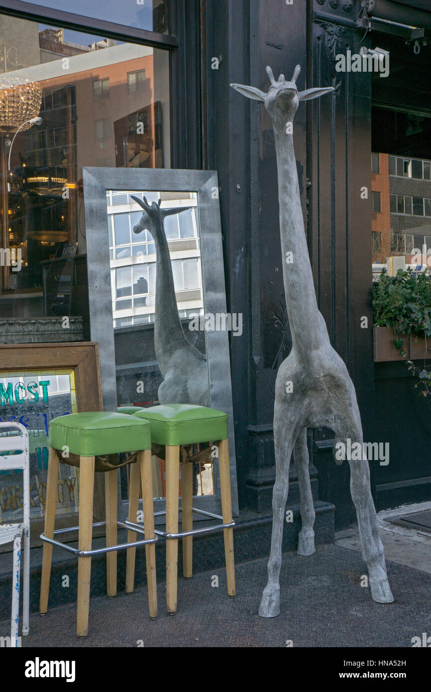 AN ugly statue of a giraffe for sale at Old Good Things antiques on Bowery in the East Village section of lower Manhattan, New York City. Stock Photo