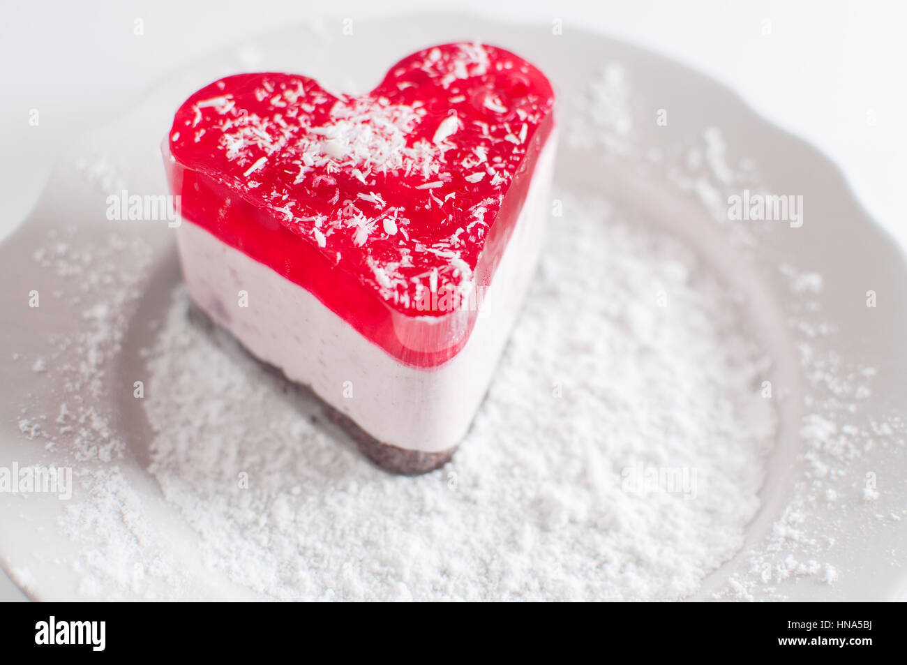 Pastry heart with jelly on white plate Stock Photo