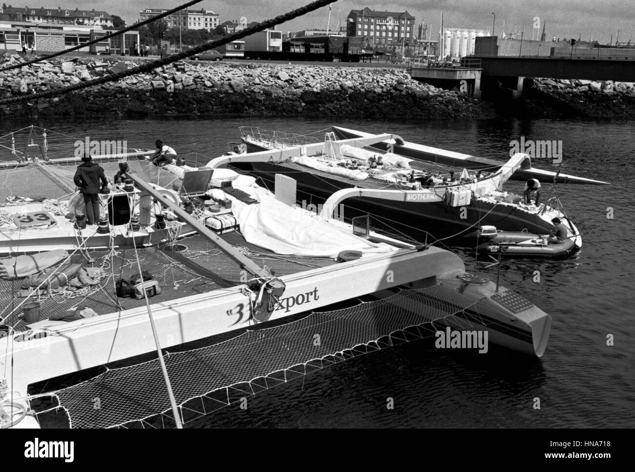 AJAXNETPHOTO. 1 JUNE,1984.PLYMOUTH, ENGLAND. -OSTAR RACE-  FRENCH YACHTS 33 EXPORT AND BIOTHERM UNDERGOING REPAIRS IN MILBAY DOCK. PHOTO:JONATHAN EASTLAND/AJAX  REF:840106 20 Stock Photo