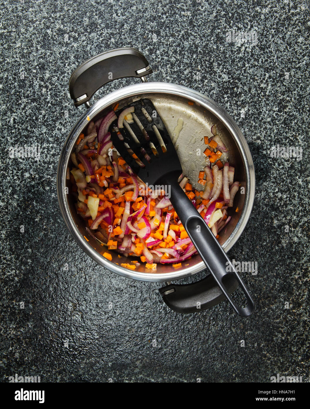 Cooking vegetables in a pressure cooker onions, carrots and spices