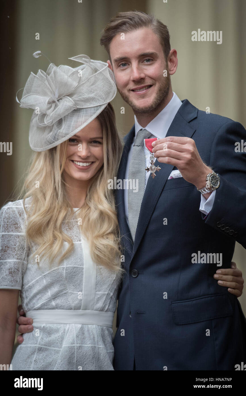 England cricketer Stuart Broad with his girlfriend Bealey Mitchell after being made a Member of the Order of the British Empire (MBE) by the Prince of Wales at an Investiture ceremony at Buckingham Palace in London. Stock Photo