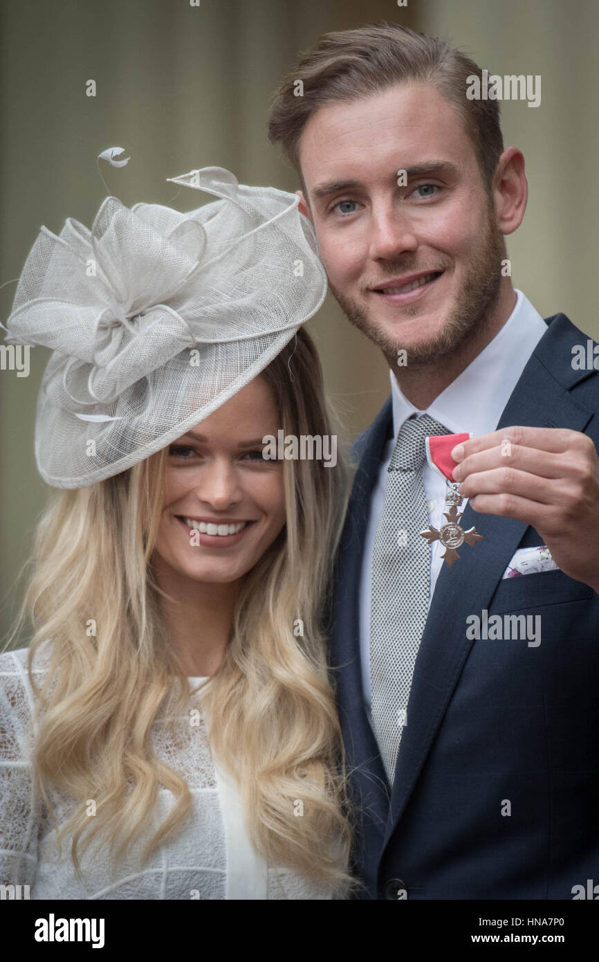 England cricketer Stuart Broad with his girlfriend Bealey Mitchell after being made a Member of the Order of the British Empire (MBE) by the Prince of Wales at an Investiture ceremony at Buckingham Palace in London. Stock Photo