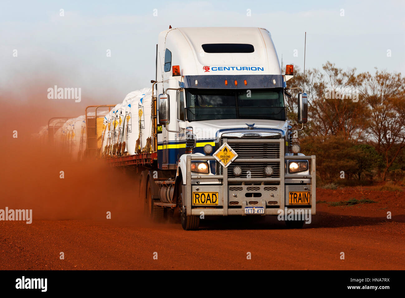 Freightliner road train truck on dusty red outback Australian road, Pilbara, Western Australia. Stock Photo